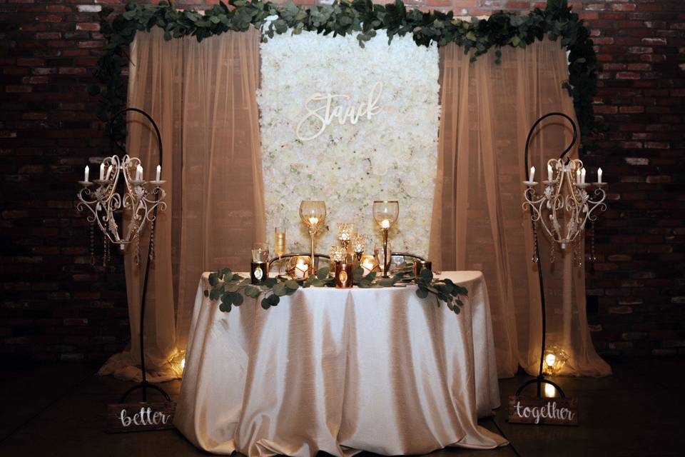 Flowerwall with gold sheer drapes and Eucalyptus
