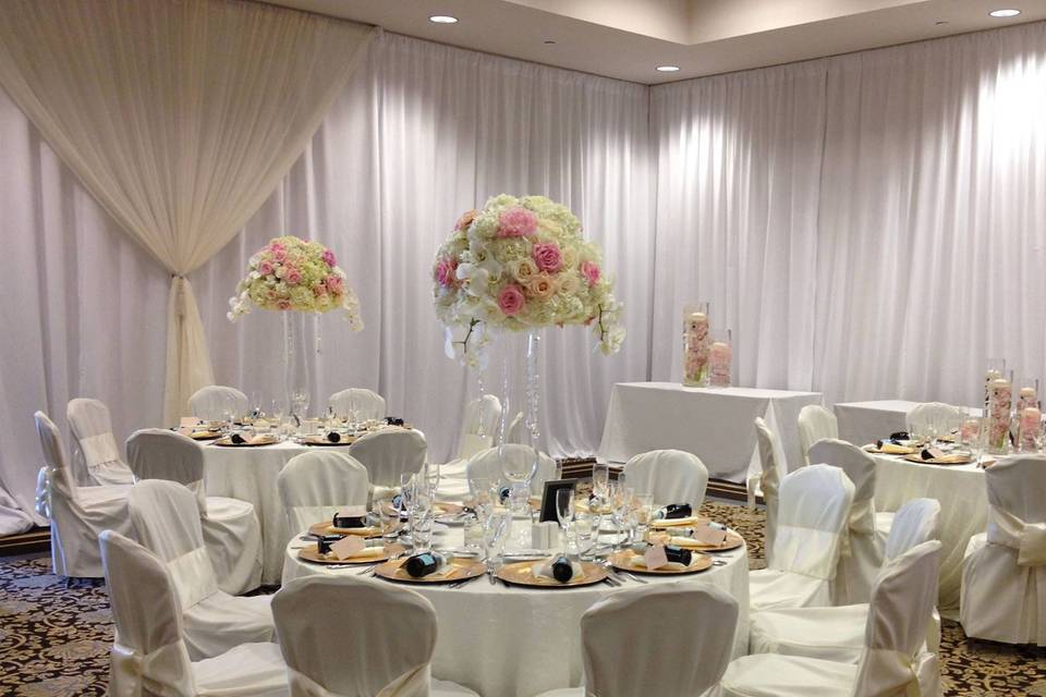 White poly wall draping with ivory hourglass
