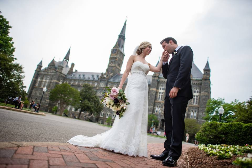 Groom kissing his bride's hand