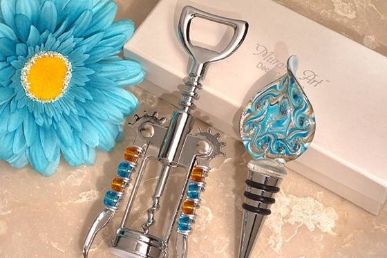 Wow your guests with our Murano Teal And Gold Bottle Stopper And Opener Set! This beautiful wine favor set features exquisite teal and gold Murano-style glass, handcrafted so that each piece is truly one-of-a-kind!