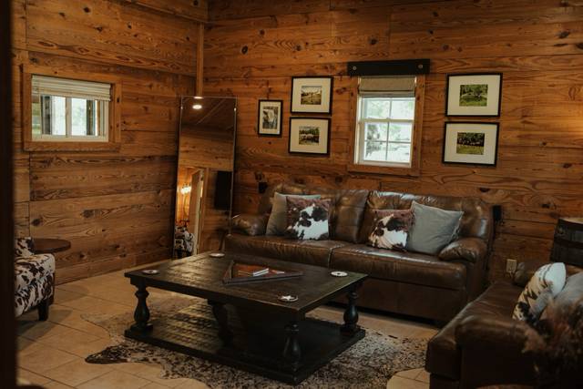 The groom's suite above the barn, with leather seating, a full-length mirror and a private deck