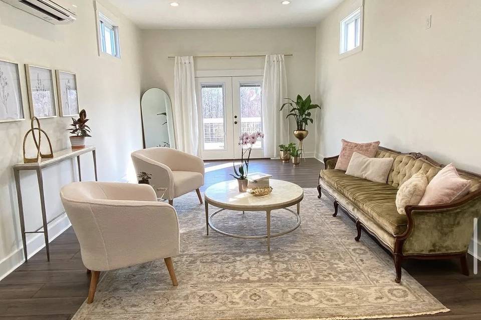 The bridal suite, with lounge seating, vanity mirrors and doors onto the balcony