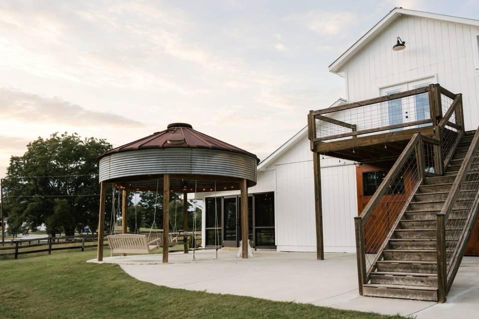 The barn at dusk, with the groom's suite and its private deck above the silo patio