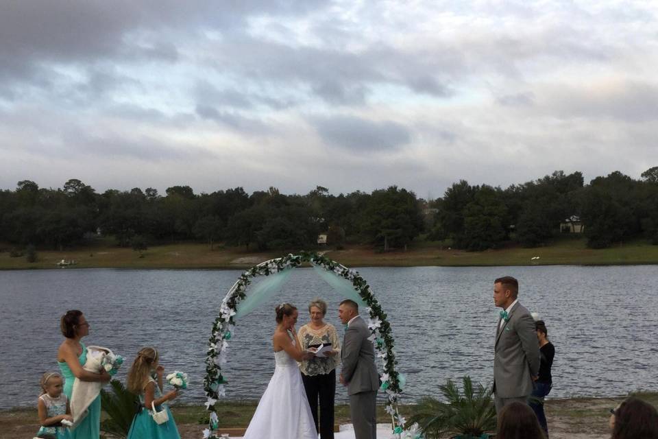 Waterfront ceremony with arch