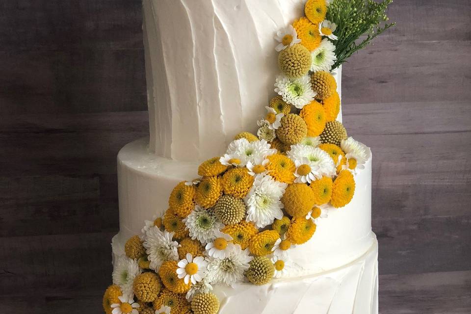 Modern floral cascade against textured buttercream