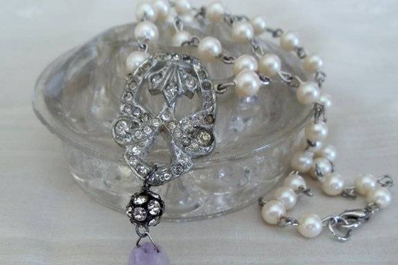This sweet necklace is delicate yet makes a statement. I've accented the beautiful antique rhinestone clip with hand wired vintage glass pearl beads a silver and rhinestone ball bead and a pretty lavender stone. It measures 17