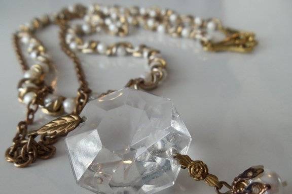 This necklace is strong yet delicate. I've used as the centerpiece for this necklace an antique chandelier crystal prism. It's hung from a brass chain and highlighted with a vintage pearl bead and gold plated necklace chain. The chain measures 24