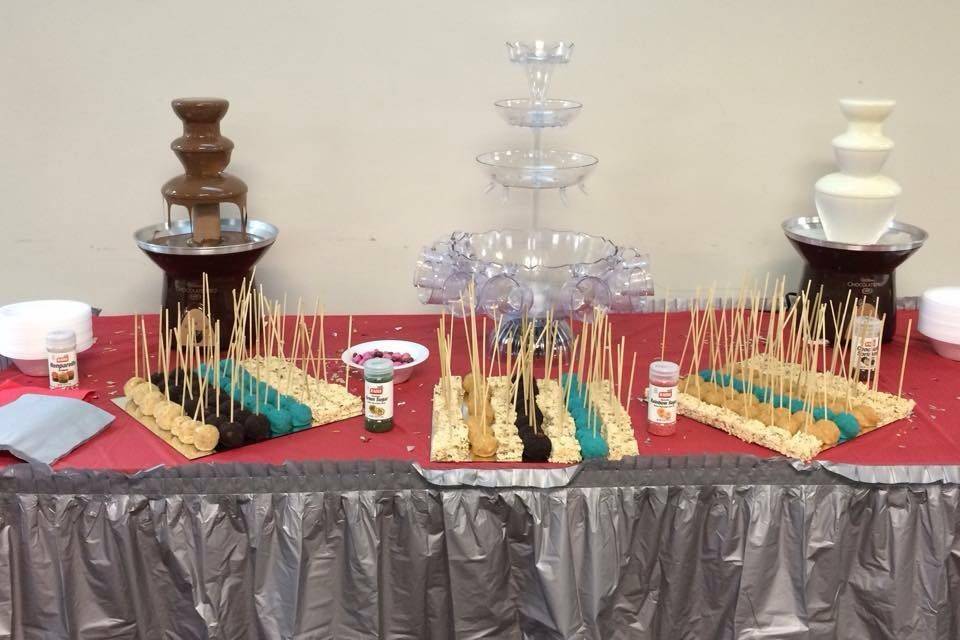 white and chocolate fountain, with peanut butter balls, cake pops, and rice krispie treats, made fresh by hand.