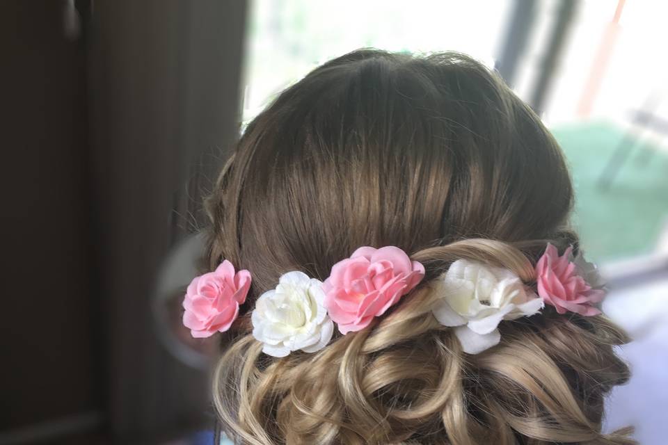 Hair updo with pink and white flowers