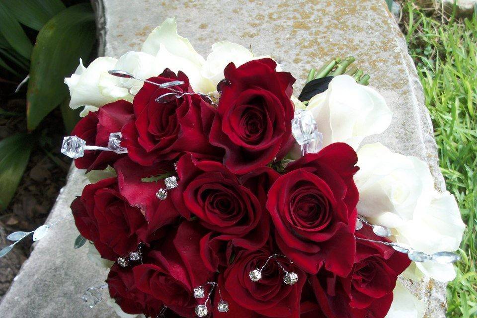 Round red rose and ivory rose bouquet with bedazzling crystal embellishments.
