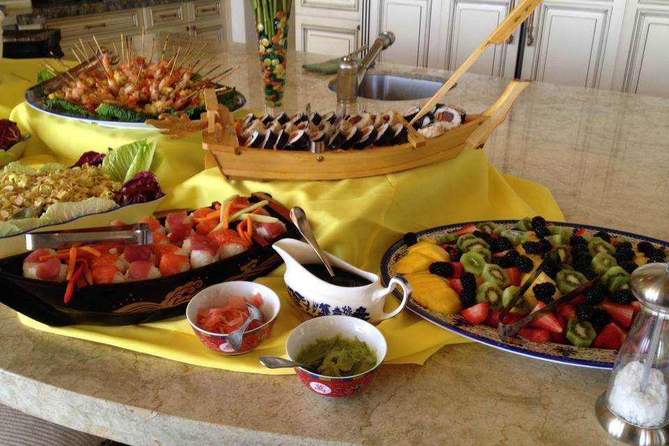 chilled sushi display along with sliced tropical fruit display