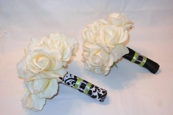 Ivory Real Touch Roses with the stems wrapped in Damask fabric with green satin ribbon accented with a rhinestone buckle and black satin ribbon.   Can be made in a variety of colors!
