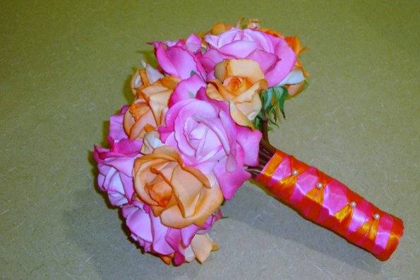 Hot Pink & Orange Real Touch Roses, 24 roses in total.  The stems are wrapped in hot pink satin ribbon and accented with orange ribbon and pearls.