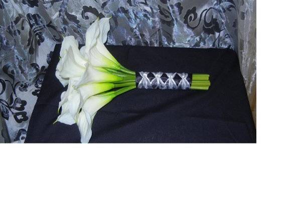 White Silk Calla Lilies wrapped in Black Satin ribbon accented with silver sheer ribbon.  This bouquet can be made in a variety of lily colors and ribbon colors to match your wedding!