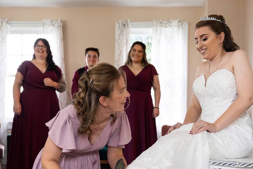 Mom Putting on Bride's Shoes