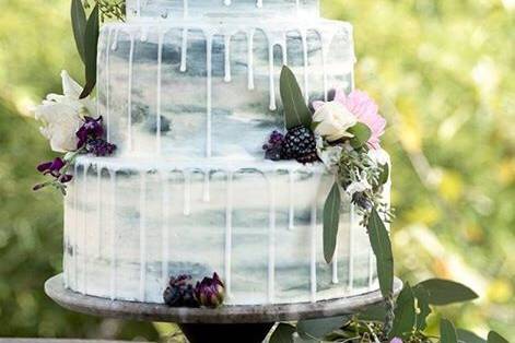 Naked wedding cake with purple flowers