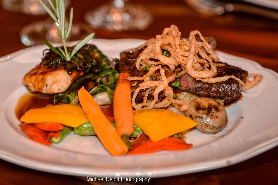 Grilled filet of wild line-caught coho salmonset atop roasted garlic mashed potato and pommes frites, napped with horseradish cream sauce and topped with sautéed spinach