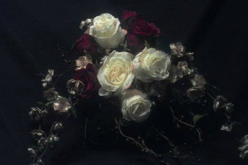 Full white & red roses accompanied by pink cherry blossom stems.