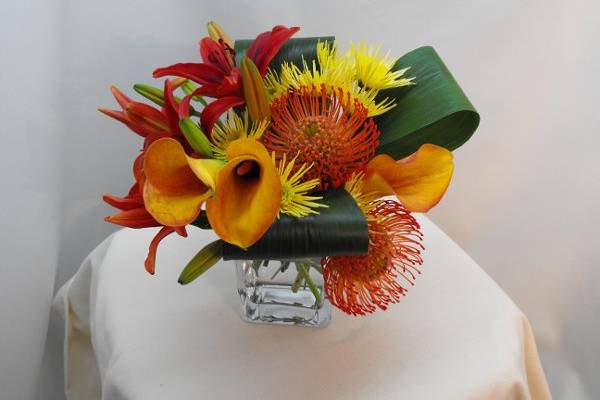 Sunset Mambo is full of passion and romance.  Calla lilies, pincushion, asiatic lilies and pom poms will brighten your tables and can be easily pulled into your bouquets.