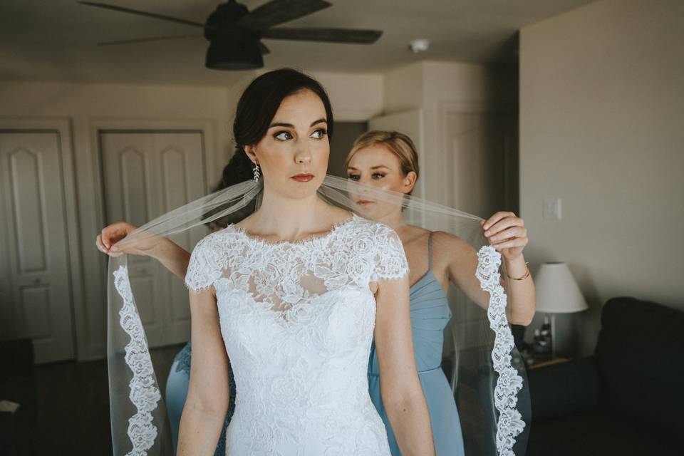 Maid of honor assisting bride