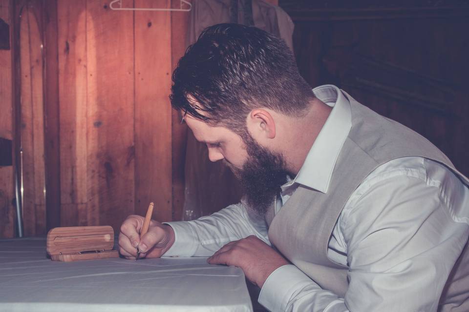 Groom writing letter to his bride.Photo by Crooked River Farm Photography LLC
