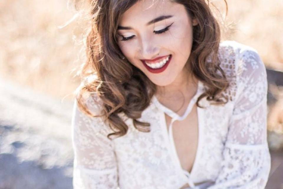 Soft skin application with a bold red lip that is sure to stand out for her engagement photo shoots. She was scared of trying a red lip, as most clients are, until I showed her how I properly apply it, to suit any skin tone. It’s okay to go bold on your wedding day!