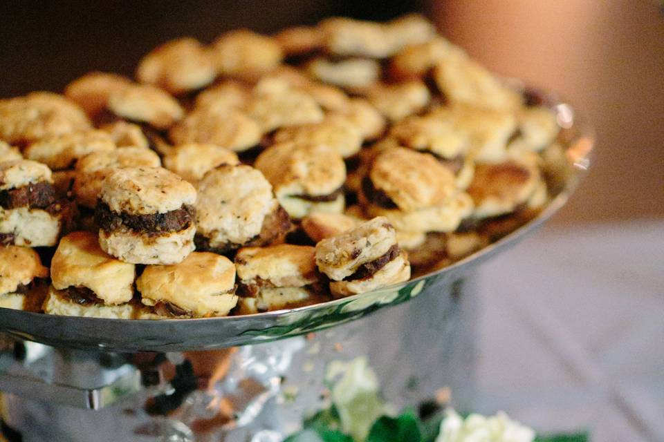 Pork tenderloin on homemade brie, sage and dried cherry biscuits with a praline pecan glaze