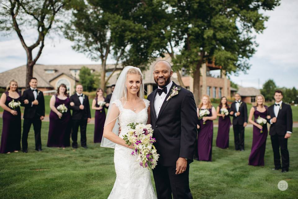 Newlyweds posing with bouquet