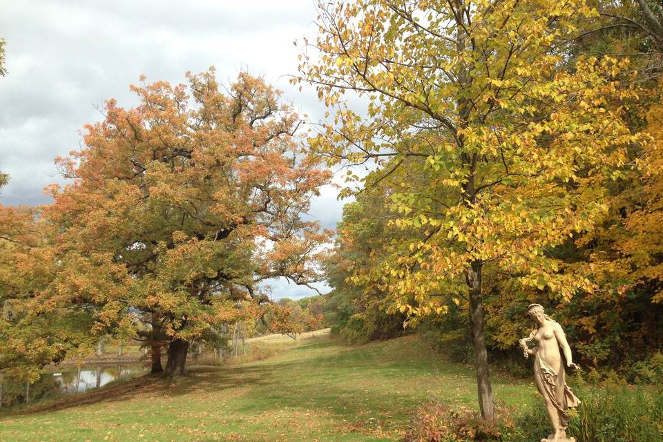 Aphrodite, the goddess of Love gracing the north grounds. Our acre pond is on the left.