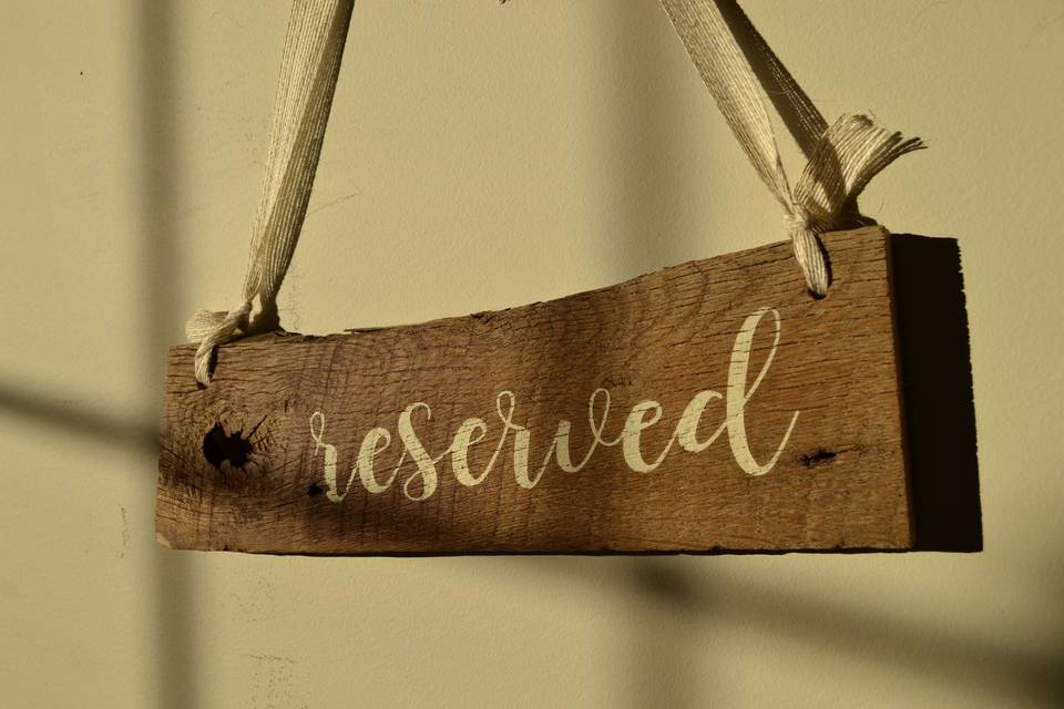 Place Reserved signs on your first isle for your special family and friends. Hand painted on reclaimed wood and hung with a delicate ribbon.