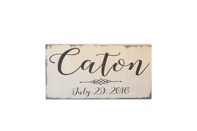 Beautifully hand painted, distressed sign with the couple's last name and wedding date.