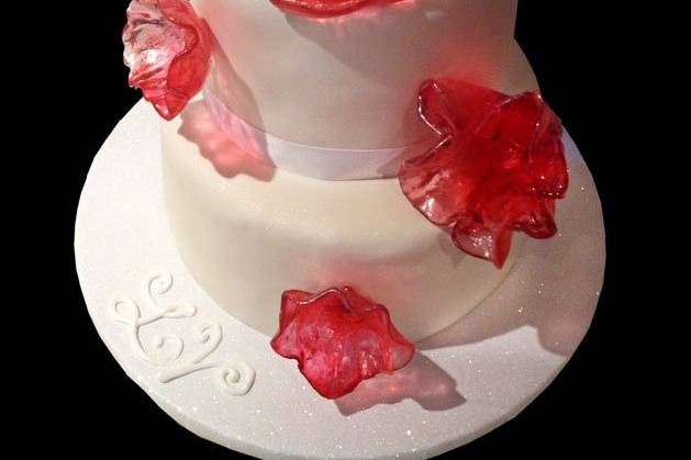 Two-tiered cake decorated with translucent pink sugar glass 