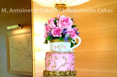 Pink, gold and lavendar rose celebration cake with sugar roses and tea cup.