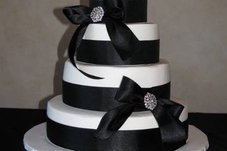Buttercream icing with satin ribbon wraps and brooches.