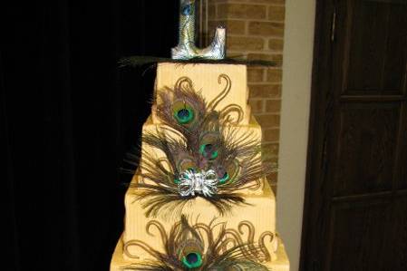 Buttercream cake with 5 different flavors. Gumpaste ebellishments, peacock feathers and brooches.