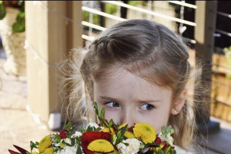 Flower girl smelling the bouquet