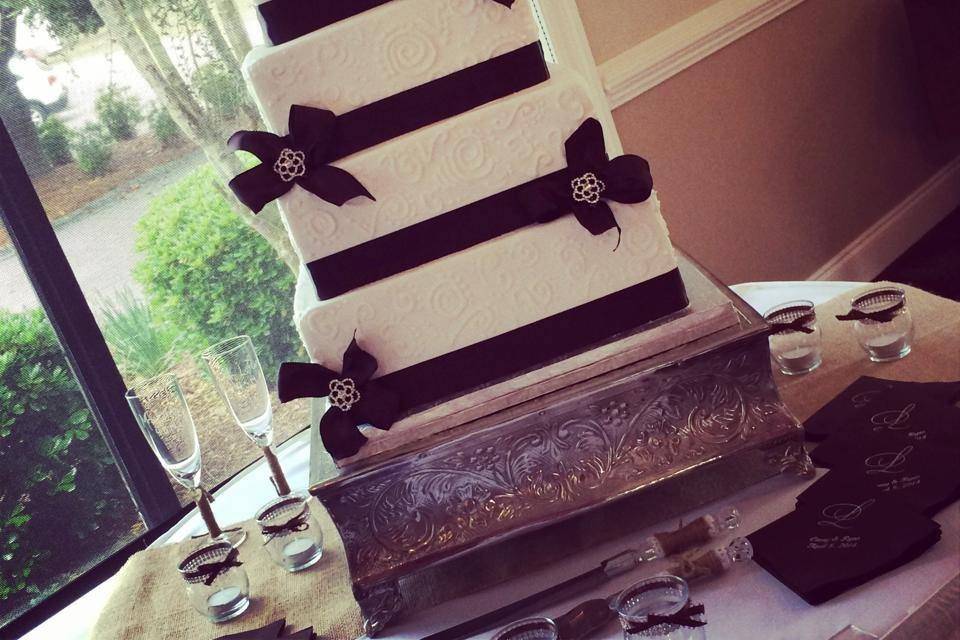 4-tier wedding cake with black ribbons