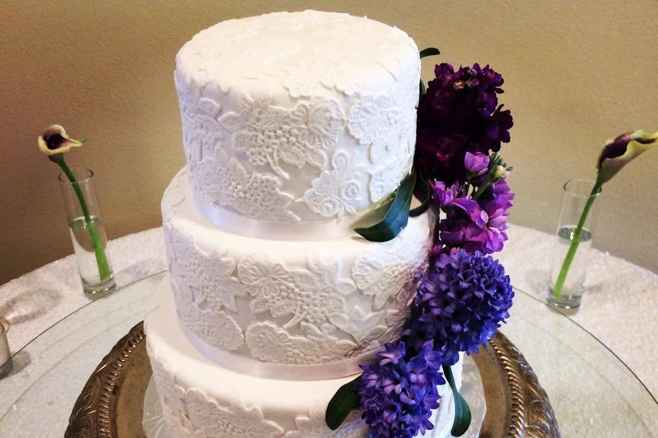 3-tier wedding cake with violet floral decor