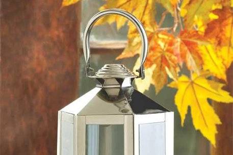 Elegant Silver Carriage Candle Lantern - Add an elegant hint of 18th century grace with this classic carriage lantern! Timeless Colonial styling gets a modern touch with highly polished silver tone finish. Handle at top for carrying or hanging