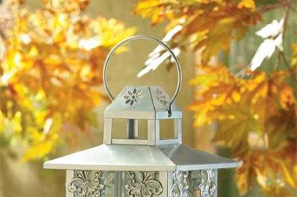 Elegant Beaded Candleholder - Refined wrought iron candle stand boasts a glamorous dash of old time Parisian elegance. Slender ivory curlicues form a stylish support for a thick pillar candle
