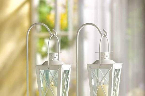 Elegant Scroll Work Silver Iron Candle Lantern - Gleaming silver finish and graceful scroll work lend old fashioned opulence to a classic candle lantern. An elegant decoration to enjoy, night and day! Perfect for a romantic touch to your wedding, or party centerpiece. Also makes an artistic display for your favorite small houseplant or miniature figurine. Handle at top for hanging. Iron and glass. Candle not included. 7 1/4