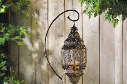 Large White Garden Lantern - Generously proportioned lantern in tones of creamy white casts fascinating illumination on an outdoor night! A graceful sweeping roof and clear glass panels add classical touches to this picturesque hanging lamp. The perfect backdrop to highlight your favorite stately pillar candle! Metal and glass. 6 1/4