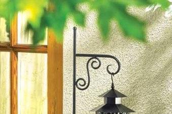 Lacy Look Moroccan Candle Lantern - The lovely lacy ivory pattern on this gorgeous lantern lets the candle light shine from the cutout designs! Hexagonal hurricane shape in creamy ivory is stunning against lush garden greenery, casting a gracious golden glow on a magical summer's night. (Candle not included.) Metal with glass. 6