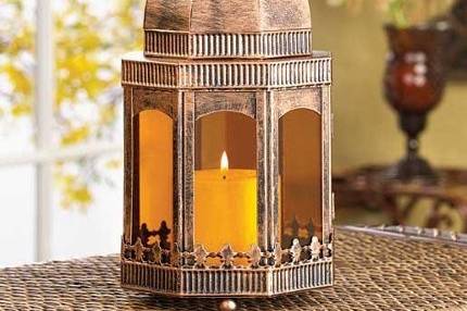 Rust Free Wrought Iron Pagoda Garden Lantern - Slender, sophisticated lamp adds the glimmer of light to a balmy outdoor night! Hummingbird and floral cutouts and antiqued ocher finish update a graceful pagoda style lantern, adding tasteful illumination to patio or path. Rust free wrought and cast iron. Candle not included. 7 1/4
