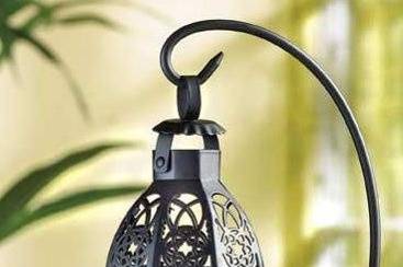 Matte Black Metal Hanging Taper Candle Lantern Chandelier - Three slender taper candles of your choosing glimmers from within the cage of this unique, dramatic hanging lantern. Matte black metal scroll work and gleaming glass panels contribute to this historical Colonial style, bringing a tasteful touch of tradition to any décor! Metal with glass panels. (Taper candles not included.) 8 1/4
