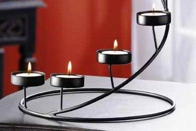 Colonial Candle Lamp - Cutouts and glass windows gleam with reflected candlelight in this colonial style metal candle lamp. Bright burnished finish and a wire hanging loop. Metal with glass windows. Uses votive candles (not included). 5