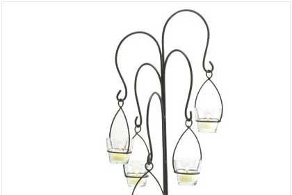 Tabletop Hanging Moroccan Lantern with Stand - This piece adds an enticing dash of Far East mystery to any tabletop or shelf! Inspired by the beauty of traditional Moroccan metalwork lamps, this free standing miniature version casts an ever changing dance of light and shadow wherever it is placed. Metal and glass. 5 1/2
