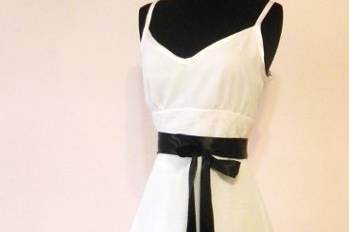 This lovely gown is tea length, chiffon with a lace insert at the waist