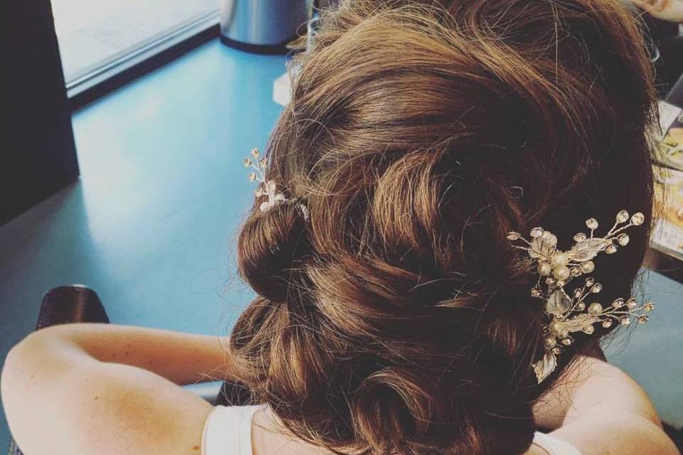Curly low bun with baby's breath