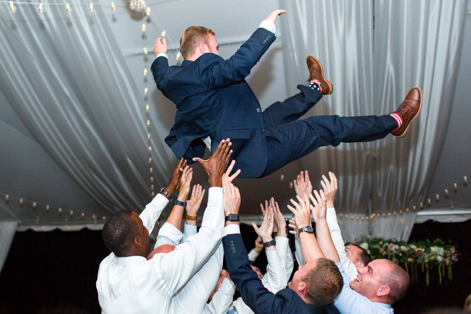 Guests throwing groom